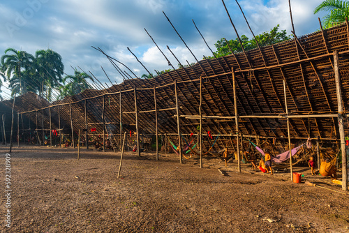 Yanomani tribal people in their traditional Shabono, rectagonal roof, Yanomami tribe, southern Venezuela photo