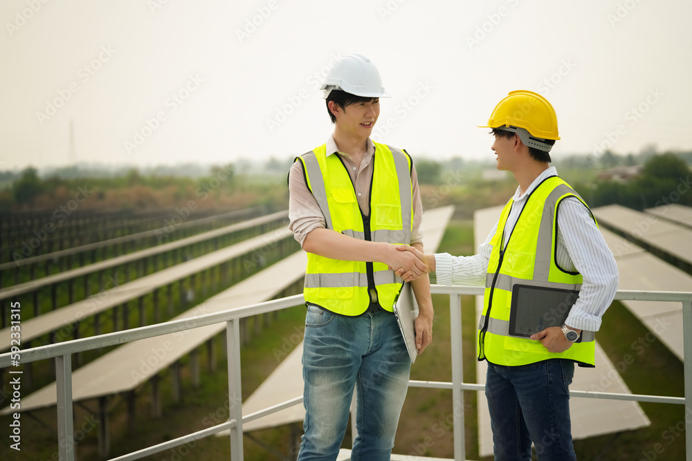 Electrician engineer with white helmet working at a photovoltaic farm, checking and maintenance equipment with instruments at industry solar power. Electrician engineer with white helmet working at a photovoltaic farm, checking and maintenance equipment with instruments at industry solar power.