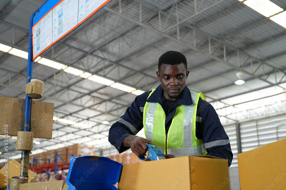 Multiethnic industrial workers checking their logistic lists while working with transportation of goods in warehouse Multiethnic industrial workers checking their logistic lists while working with transportation of goods in warehouse