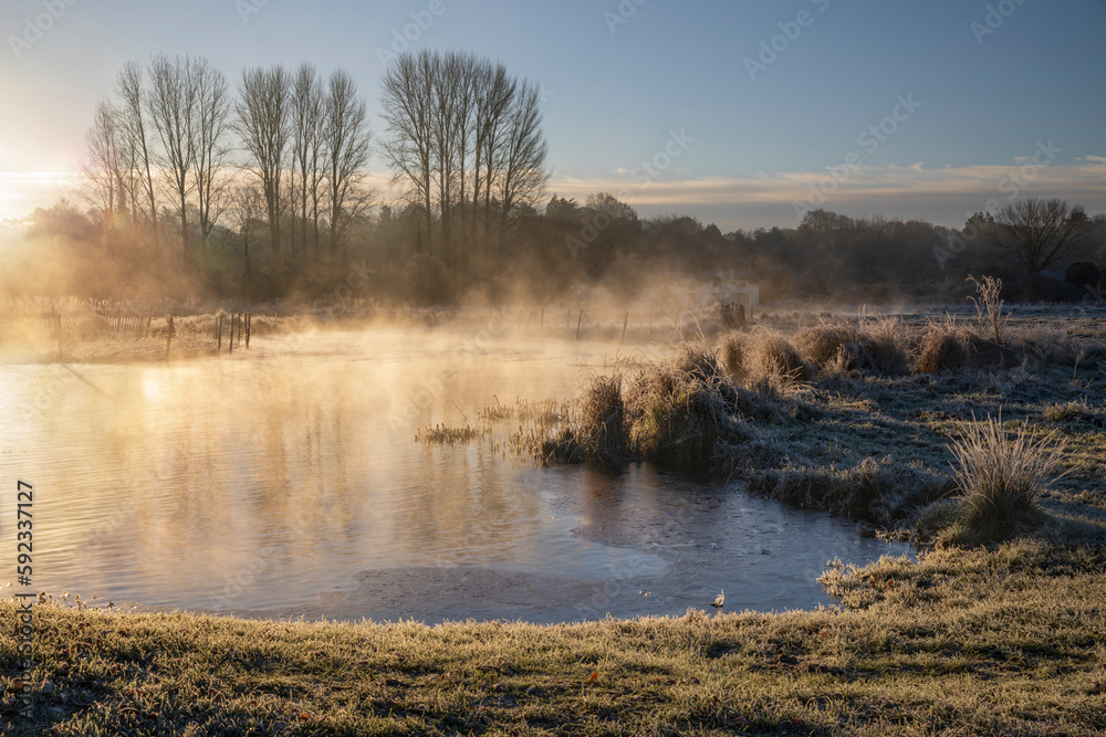 Frosty winter sunrise with mist on the River Test on Chilbolton Cow Common SSSI (Site of Special Scientific Interest), Wherwell, Hampshire Frosty winter sunrise with mist on the River Test on Chilbolton Cow Common SSSI (Site of Special Scientific Interest), Wherwell, Hampshire