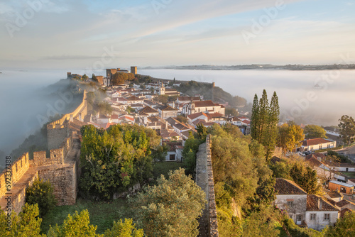 Fog at sunrise over Obidos old town and rampart defensive walls, Obidos, Centro Region, Estremadura, Portugal photo