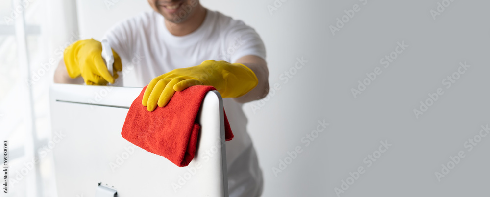 Close up view of man cleaning desktop computer using clothes. Cleaning office desk concept. Close up view of man cleaning desktop computer using clothes. Cleaning office desk concept.
