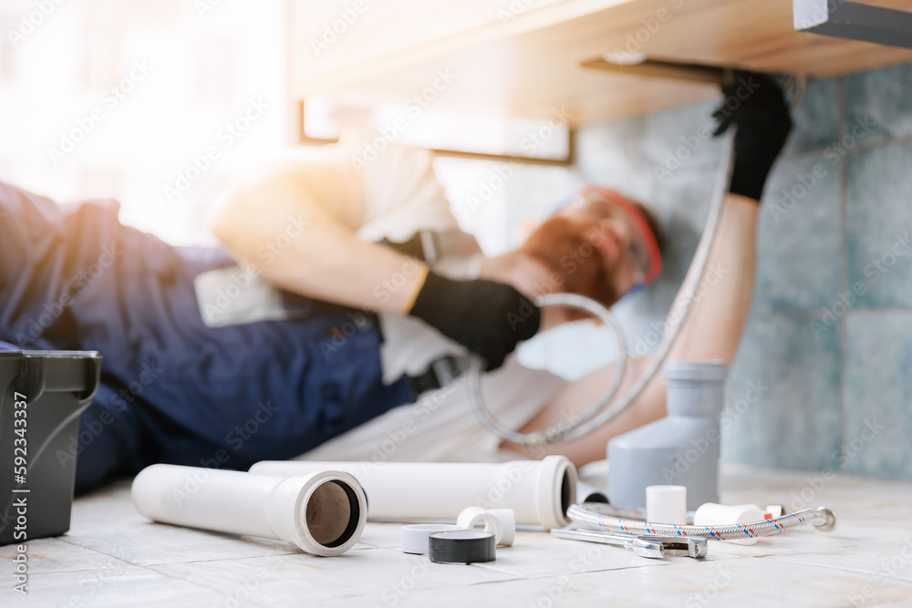 Plumber man at work in bathroom, fix repair service. Concept assemble and install plumbing Plumber man at work in bathroom, fix repair service. Concept assemble and install plumbing