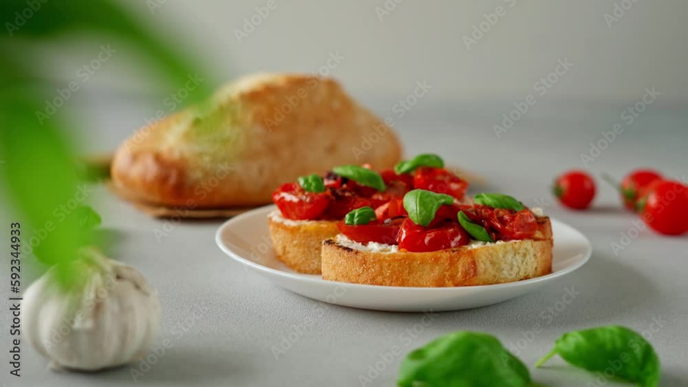 Bruschetta with Ricotto cheese and cherry Tomatoes, basil, garlic on a grey concrete background. Food. Food background. Close-up Bruschetta with Ricotto cheese and cherry Tomatoes, basil, garlic on a grey concrete background. Food. Food background. Close-up