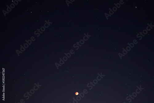 Lunar eclipse blood moon with starry in the night sky