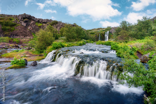 Fototapeta Naklejka Na Ścianę i Meble -  Gjain waterfall flowing with lush jungle in Pjorsardalur valley on summer at Iceland