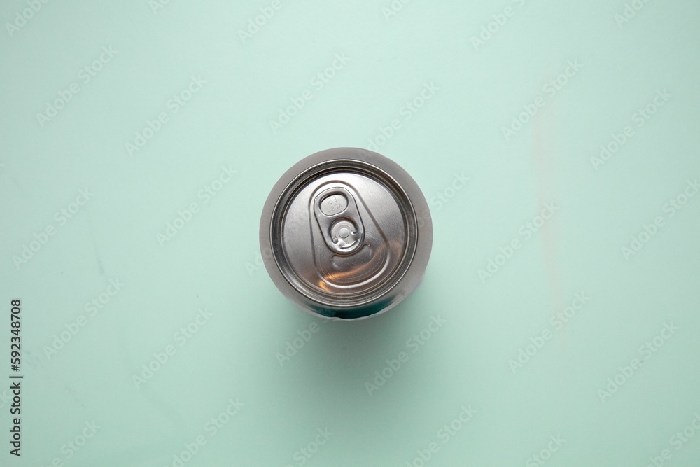 Closeup top view of a metal can on a blue surface Closeup top view of a metal can on a blue surface