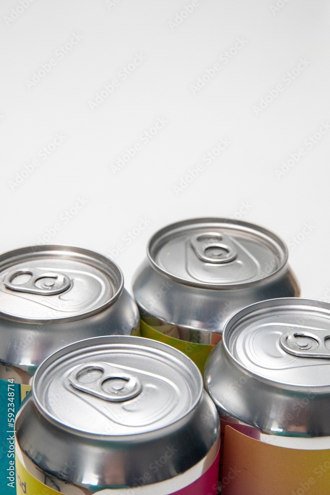 Vertical closeup view of four metal beverage cans Vertical closeup view of four metal beverage cans