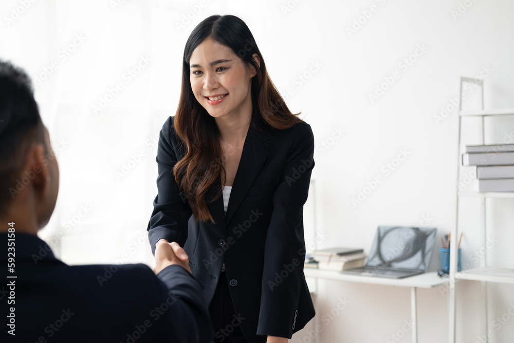 Young business people shaking hands in the office. Finishing successful meeting. Young business people shaking hands in the office. Finishing successful meeting.