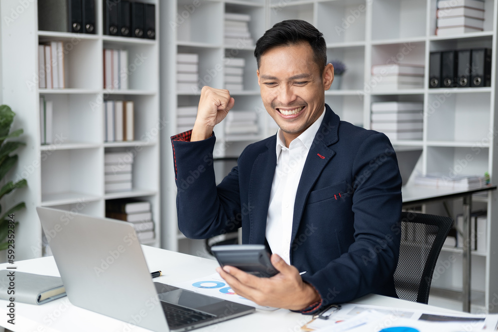 Smiling businessman feeling happy after get the good result from calculating. Smiling businessman feeling happy after get the good result from calculating.
