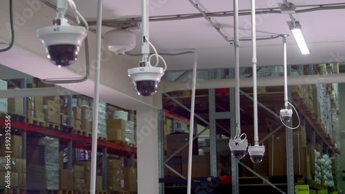 Five panoramic security cameras record storehouse. Panoramic surveillance cameras film activity in warehouse at present time