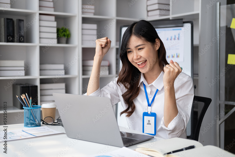Successful young businesswoman celebrate her victory at the modern office room. Business achievement concept . Successful young businesswoman celebrate her victory at the modern office room. Business achievement concept .