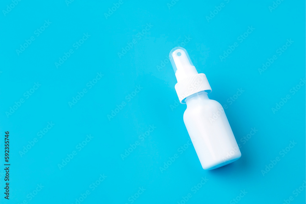 White plastic package of nasal spray on a blue background. Treatment of seasonal allergies. Top view, space for text. White plastic package of nasal spray on a blue background. Treatment of seasonal allergies. Top view, space for text.
