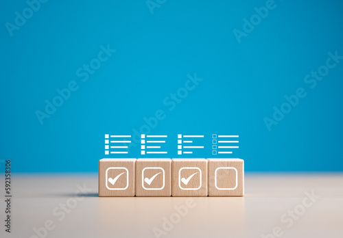 Checklist, Task list, Survey and assessment. Confirmation or Double check. Quality Control. Goals achievement and business success. Check mark and jobs list icon on wooden blocks.