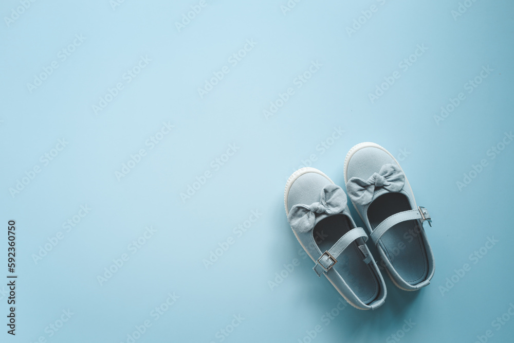 Child's shoes on color background top view, flat lay Child's shoes on color background top view, flat lay