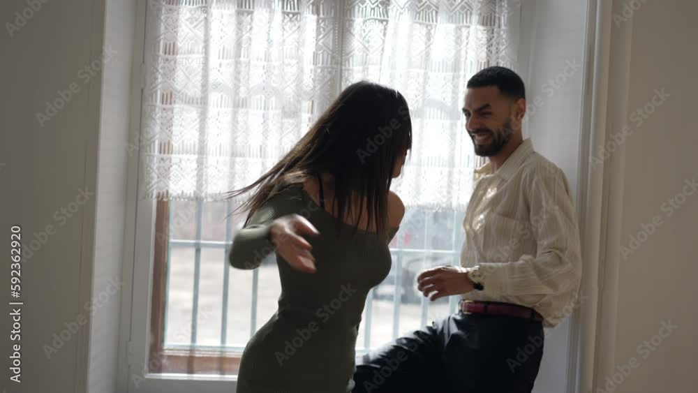Couple teasing each other. Girlfriend pushes but embraces boyfriend in a funny manner. Candid authentic loving relationship making reconciliation after fight Couple teasing each other. Girlfriend pushes but embraces boyfriend in a funny manner. Candid authentic loving relationship making reconciliation after fight