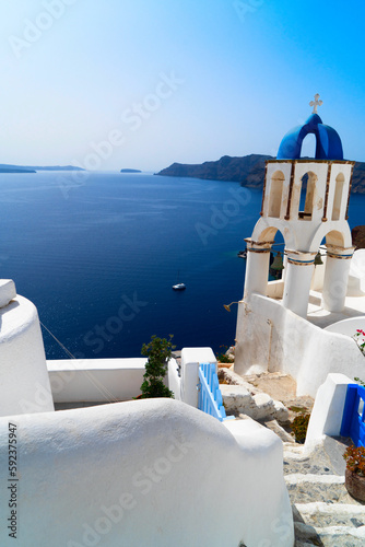traditional greek village Oia of Santorini, with stairs and blue dome, Greece