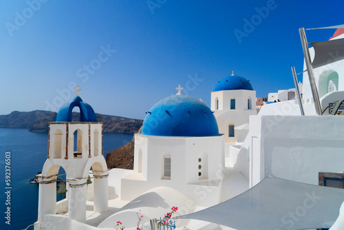 traditional greek village Oia of Santorini, with blue domes against sea and caldera, Greece
