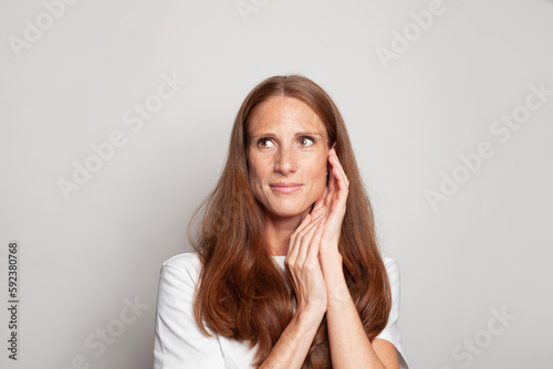 Attractive mid adult woman on white background, portrait