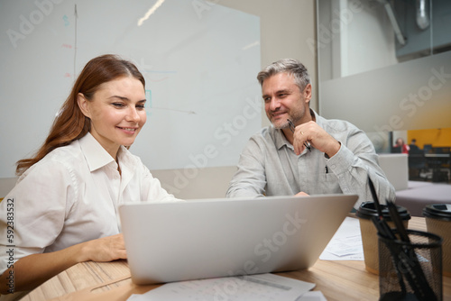 Young woman talking with man in the office