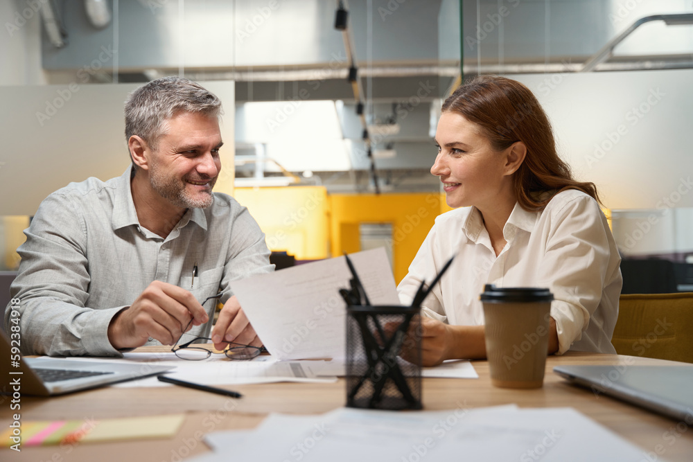 Male and woman discussing contract in the office Male and woman discussing contract in the office
