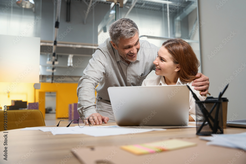 Woman and man happy for work results in the office Woman and man happy for work results in the office