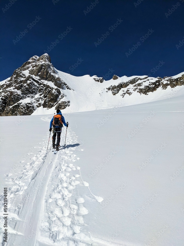 Ski tourers on the Clariden Glacier on their way towards the Tüfelsjoch Bocktschingel. High quality photo
