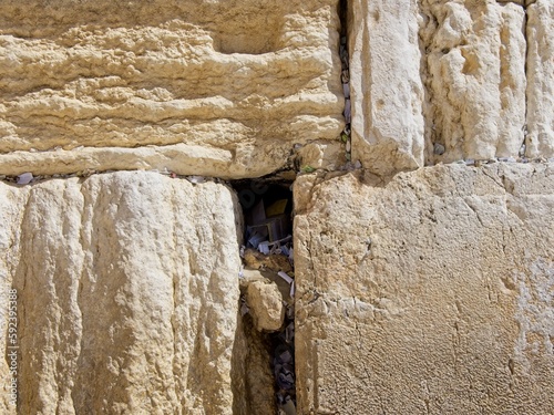 Fototapeta Naklejka Na Ścianę i Meble -  Texture of the stones with notes inserted in crevices of the  Western Wall (Wailing Wall), Jerusalem, Israel