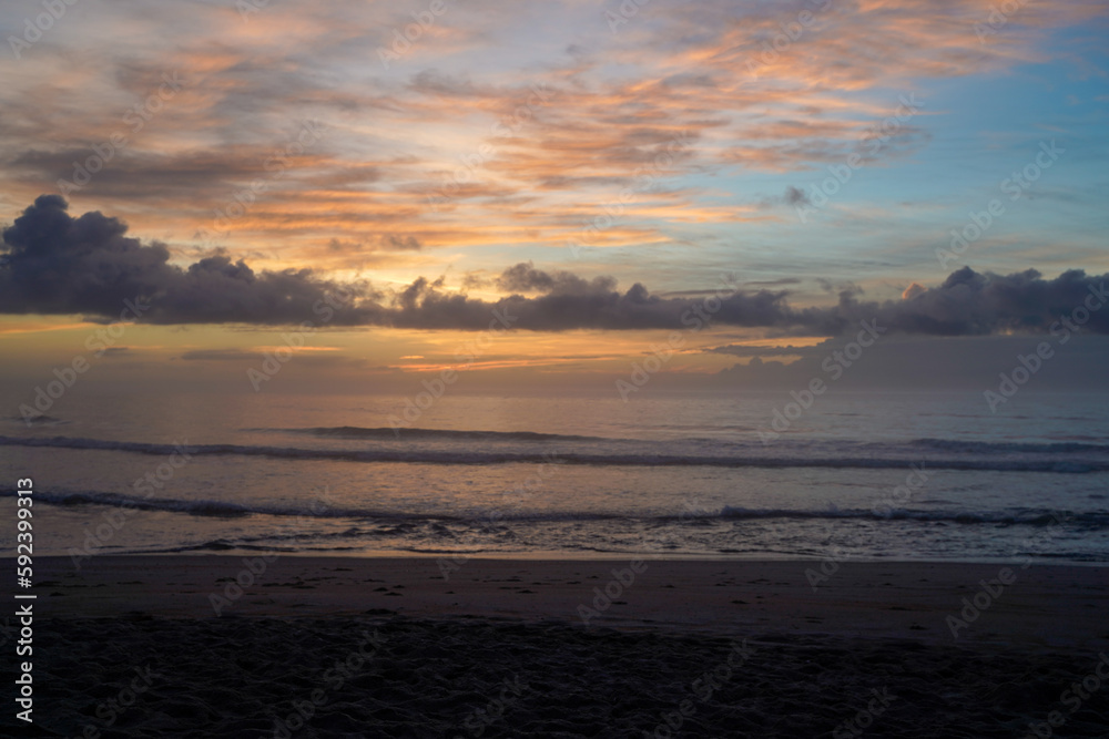 Sunset on the beach with calm waves