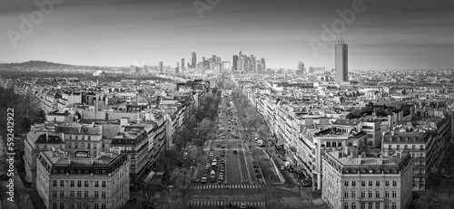Black and white Paris cityscape panorama with view to La Defense metropolitan district, France. Champs-Elysee avenue, beautiful parisian architecture, historic buildings and landmarks on the horizon