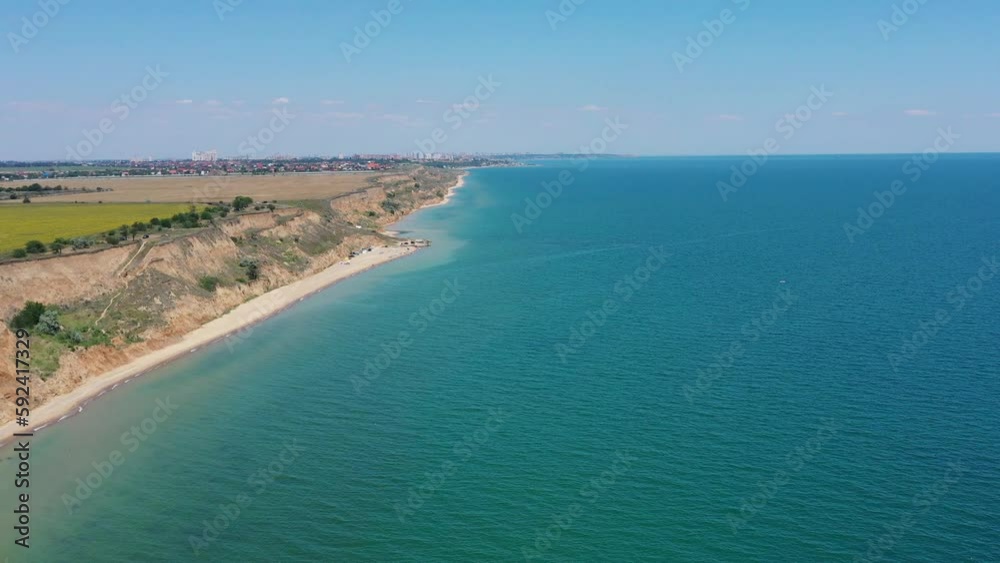 Panorama of sea shore in South Ukraine, Europe. Resort city with nice sand beach and clear blue sea. travel destination, ideal place for comfort vacation on black Sea. Drone video.