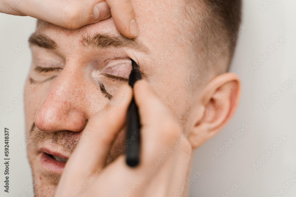 Close-up male blepharoplasty for man markup on the face before plastic surgery operation for modifying the eye region in medical clinic. Close-up male blepharoplasty for man markup on the face before plastic surgery operation for modifying the eye region in medical clinic.