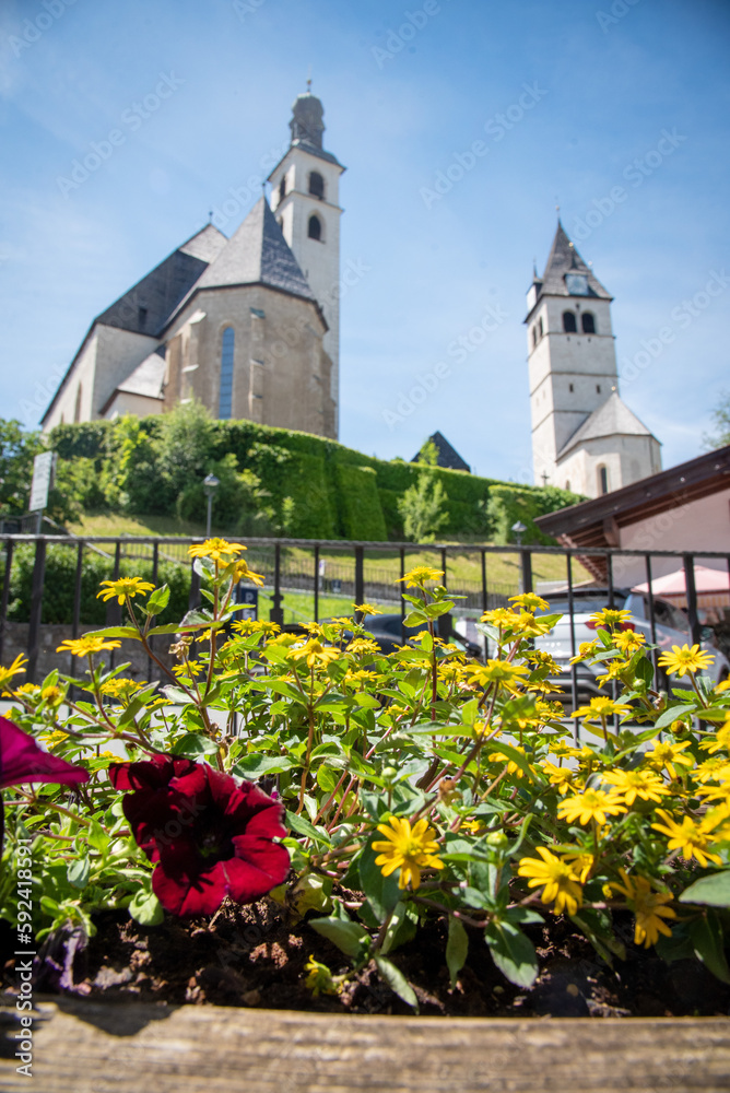 Spring flowers in an alpine town of Kitzbuhel with its architecture in Tirol, Austria  
