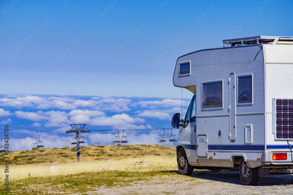 Rv camper in mountains above clouds Rv camper in mountains above clouds