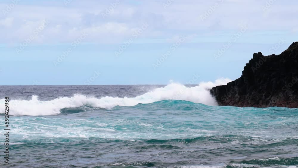 Big waves hit a rocky beach. Shot at Charco Azul, La Palma, Spain. Big waves hit a rocky beach. Shot at Charco Azul, La Palma, Spain.