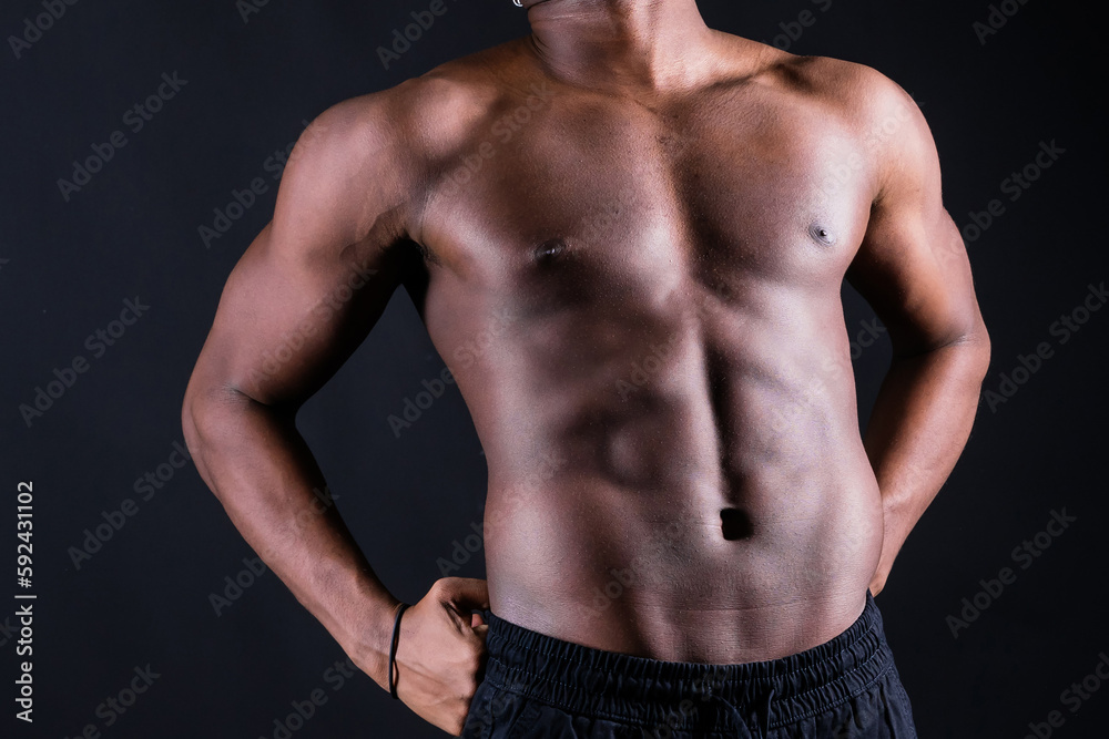 Isolated african muscular man with dumbbells on dark studio background. Strong shirtless black guy Isolated african muscular man with dumbbells on dark studio background. Strong shirtless black guy