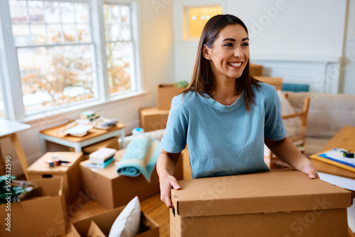 Young happy woman moving into her new apartment. © Drazen