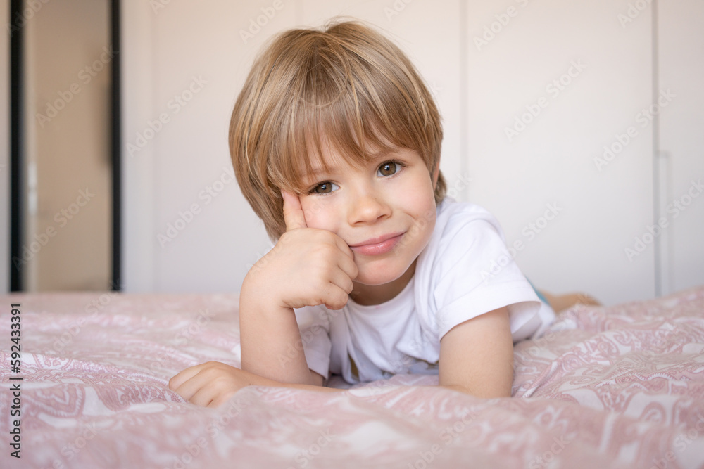 Morning of cute little child boy showing thumb-up in bed Morning of cute little child boy showing thumb-up in bed