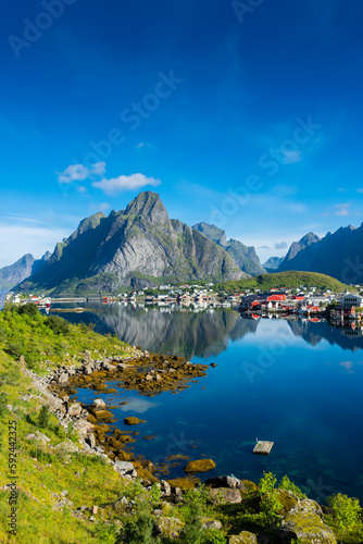 Fototapeta Naklejka Na Ścianę i Meble -  Perfect reflection of the Reine village on the water of the fjord in the Lofoten Islands,  Norway