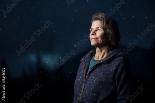 Portrait of a beautiful senior woman on a background of the night sky