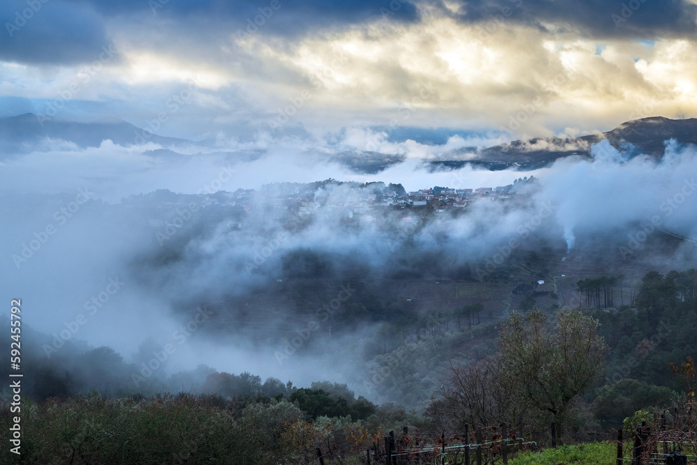 Fototapeta premium Landscape of the village of Sabroso on the outskirts of Vila Real in Portugal, shrouded in clouds and mist after heavy rain, on a stormy day.