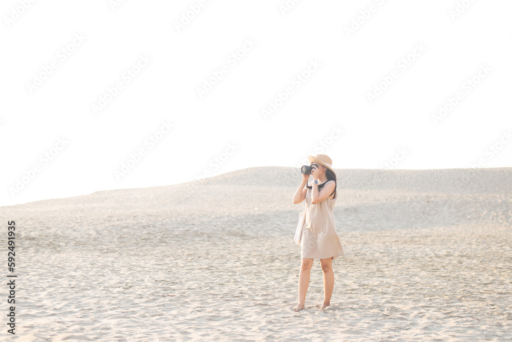 Travellers asian woman taking a photo with digital camera at desert Travellers asian woman taking a photo with digital camera at desert