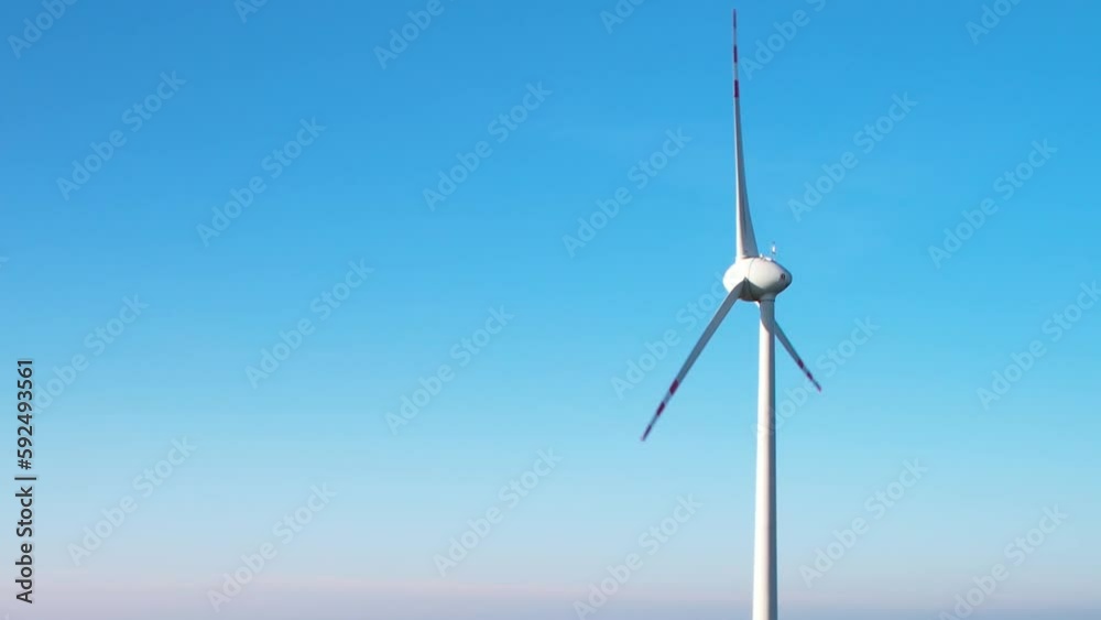 One wind turbine against clear blue sky - clean energy concept One wind turbine against clear blue sky - clean energy concept