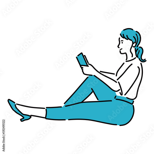 床に座って読書してリラックスしている若い女性
