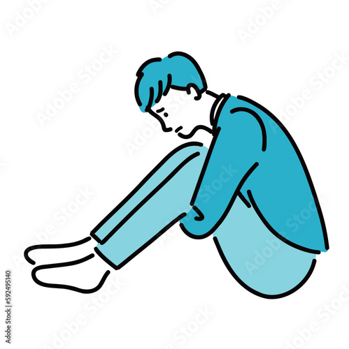 抑うつで膝を抱えて悩んでいる男性
