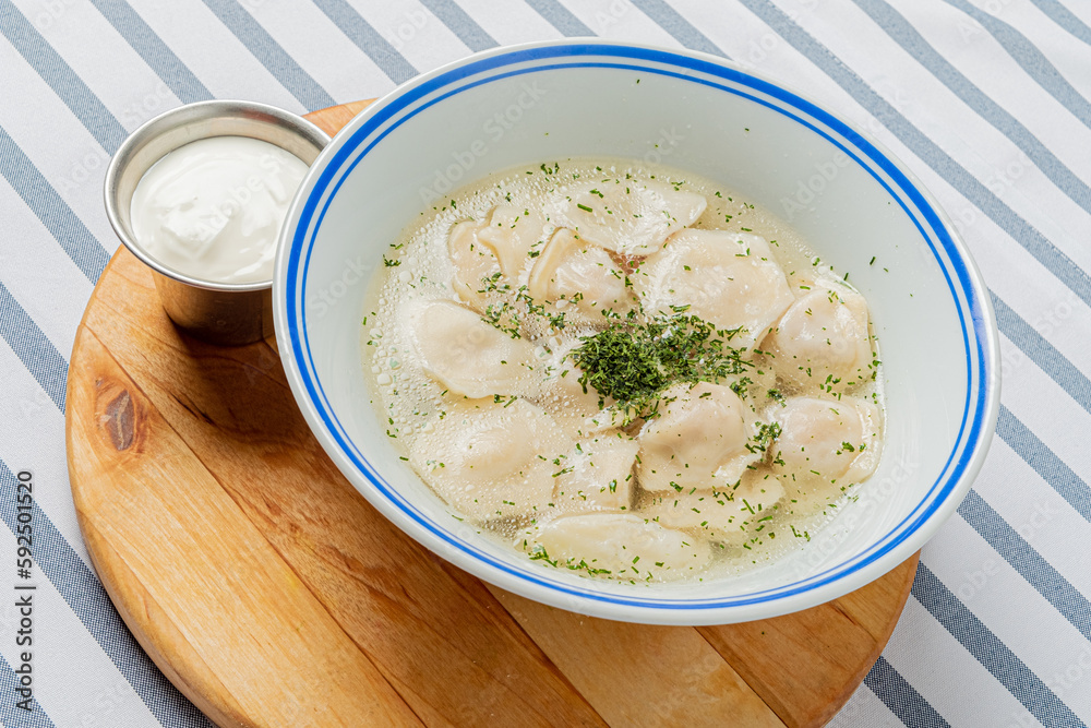 dumpling with broth and sour cream