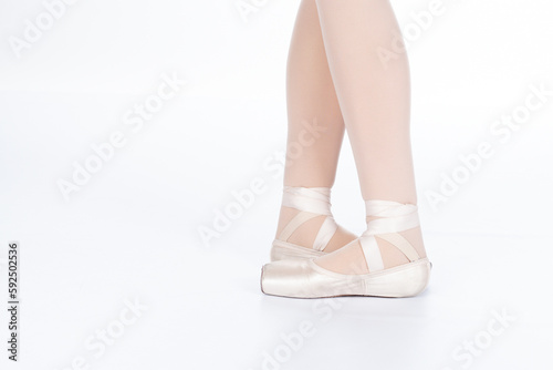 En Pointe CORRECT Fifth position closed with calves front on teachers perspective Close up of young female ballet dancer showing various classic ballet feet positions pointe shoes