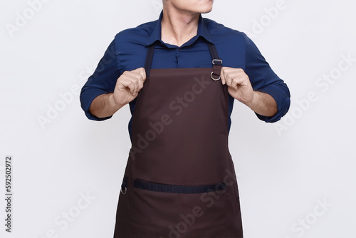 Asian Man wearing Apron in casual stylish clothing, standing tall pose with both hands straightening his apron, ready to work gesture, no face isolated white background