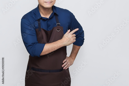 Asian Man wearing Apron in casual stylish clothing, standing upright pose with one hand pointing at something on the right, no face isolated white background
