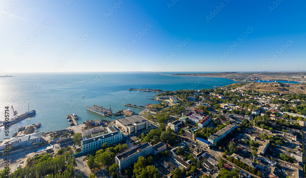 Kerch, Crimea - August 31, 2020: Panorama of the city, port and Crimean bridge from the air